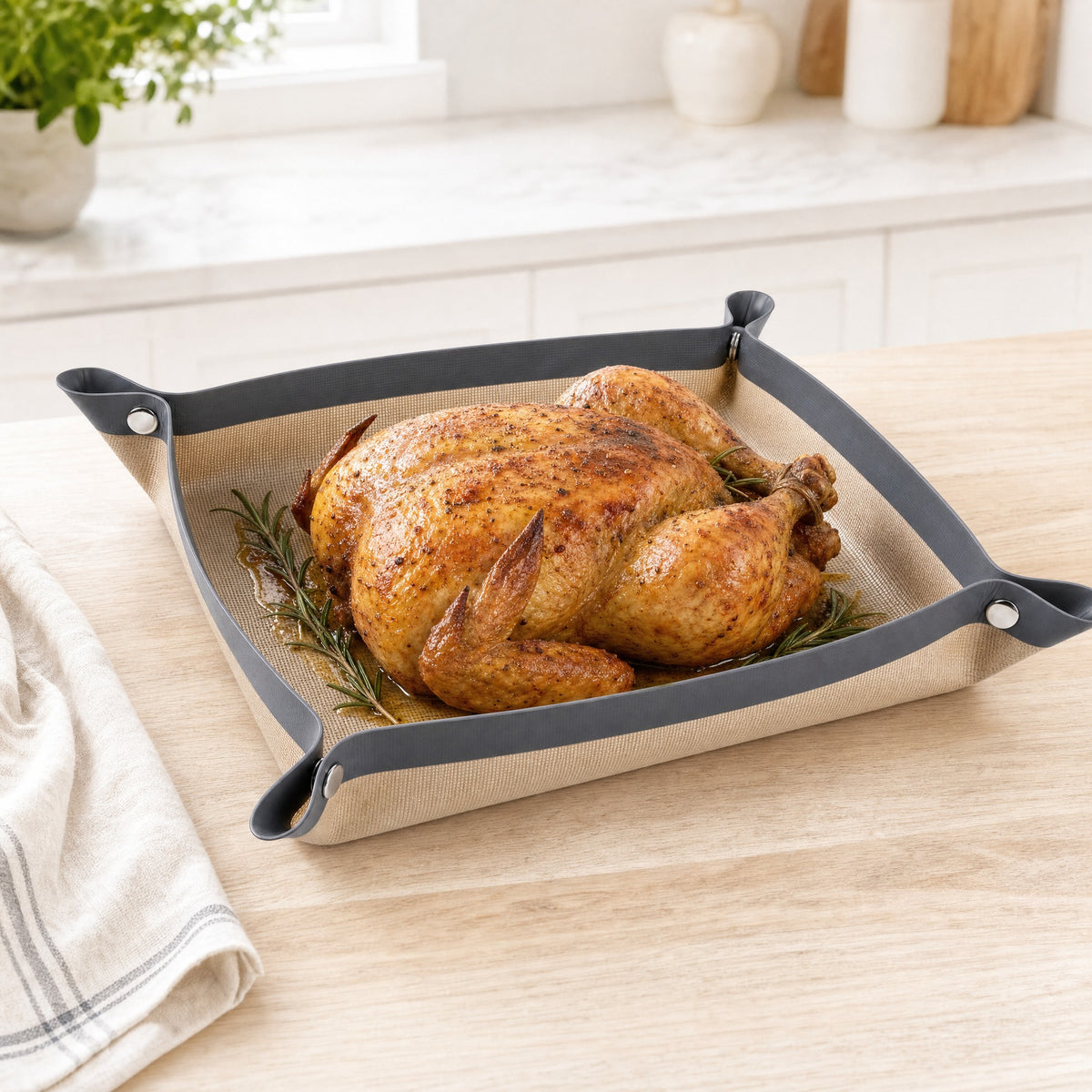Snap Tray snapped up into a tray holding a golden roast chicken on a kitchen counter